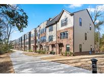 Townhomes with brick and siding, offering a charming and modern aesthetic at 352 Twinflower Ln, Charlotte, NC 28205