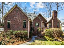 Charming red brick home with a well-maintained lawn and mature landscaping, perfect for curb appeal at 411 Major Run, Cramerton, NC 28032