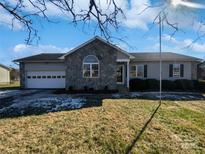 Ranch home with stone accents and a two-car garage at 495 Drumstand Rd, Stony Point, NC 28678