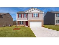 Two-story house with a red door and attached garage, fresh landscaping at 5149 Fireweed Ct, Dallas, NC 28034
