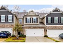 Modern 2-story townhome with stone and shingle accents, 2-car garage, and landscaped front at 6129 Artigas Dr, Indian Land, SC 29707