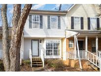 Inviting exterior of a charming townhome, featuring a brick facade and a welcoming front porch at 6303 Windsor Gate Ln, Charlotte, NC 28215