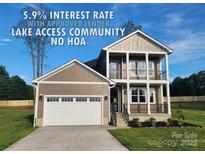 Stunning two-story home boasts a welcoming front porch and an attached two-car garage at 8078 Blackwood Rd, Denver, NC 28037