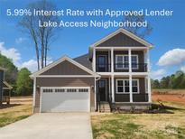Charming two-story home with a two-car garage, dark siding, and lake access neighborhood at 8078 Blackwood Rd, Denver, NC 28037
