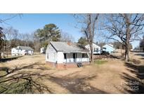 Aerial view of a small white house with a porch and surrounding houses at 1024 Chester Ave, Great Falls, SC 29055