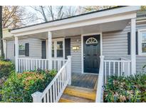 Gray house with white trim, covered porch, and manicured landscaping at 109 Belton Ave, Mount Holly, NC 28120