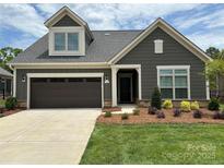 Gray house with brown garage door and landscaping at 1330 Millview Ln, Matthews, NC 28104