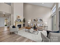 Spacious living room with fireplace, plush seating, and abundant natural light at 203 Riverview Ter, Clover, SC 29710