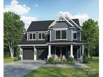 Charming two-story home with dark gray siding, a two-car garage, and a manicured front lawn at 2629 Ritz Ln, Matthews, NC 28105