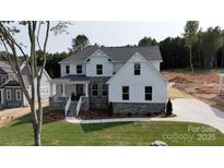 Beautiful two-story home featuring white siding, stone accents, gabled roof, and a well-manicured lawn at 4257 Candlewood Dr # 7, Sherrills Ford, NC 28673