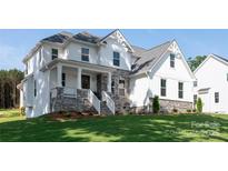 Beautiful two-story home with a stone foundation, covered porch, and lush green lawn at 4257 Candlewood Dr # 7, Sherrills Ford, NC 28673