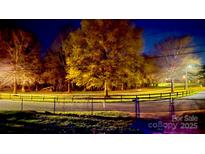 A beautiful night landscape showcasing lit trees, walking path, and neighborhood park at 85 5Th St, Cramerton, NC 28032