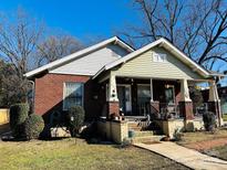 Brick house with front porch, landscaping, and a spacious yard at 224 E Steele St, Salisbury, NC 28144