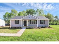 Charming single story home featuring gray siding, black shutters, and a well-manicured lawn at 3321 15Th Sw Ave, Hickory, NC 28602