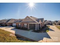 Brick ranch home with screened porch and landscaped yard at 8176 Viscount Ct, Denver, NC 28037