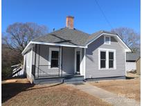 Gray house with a gray roof, small front porch, and walkway at 107 Meadow Ne Ave # 7, Concord, NC 28025