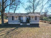 Cozy gray house with small front porch, surrounded by trees at 539 Dawn Cir, Charlotte, NC 28213