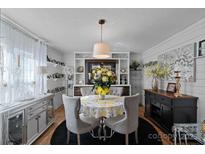 Bright dining room with a round table and built-in shelving at 5826 Boxer Dr, Iron Station, NC 28080