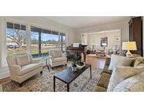 Living room with hardwood floors, ample natural light, and comfortable seating at 7135 Folger Dr, Charlotte, NC 28270