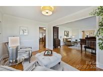 Inviting living room features hardwood floors, neutral colors, and plenty of space for entertaining guests at 7135 Folger Dr, Charlotte, NC 28270