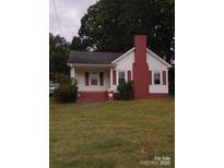 Charming white house with red brick accents and a spacious lawn at 903 Belmont Mount Holly Rd, Belmont, NC 28012
