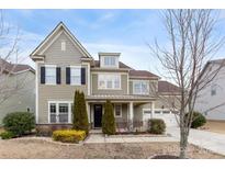 Charming two-story home with manicured landscaping, attached garage, and welcoming front entry at 11519 Sweet Birch Ln, Charlotte, NC 28278