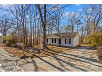 Ranch style home with mature trees and a paved driveway at 116 Westover Ave, Kannapolis, NC 28081