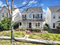 Two-story house with gray siding, dark metal roof, and a front porch at 11615 Kingsley View Dr, Charlotte, NC 28277