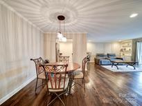 Bright dining area with wood floors and a charming table set for four at 1323 Queens Rd # 407, Charlotte, NC 28207