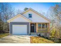 Gray house with white accents, a brown door, and a small porch at 1460 23Rd Sw St, Hickory, NC 28602