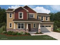 Two-story house with a blend of neutral and burgundy siding, stone accents, and a two-car garage at 1709 Honey Trl, Monroe, NC 28112