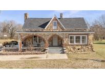 Stone house with arched entryway, porch, and large windows at 200 Church Dr, Shelby, NC 28150