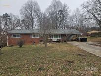 Brick ranch house with a carport and a spacious yard at 2518 Cove Creek Dr, Gastonia, NC 28056