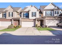 Modern two-story townhome with attached garage and well-manicured landscaping at 6417 Union Station Ct, Charlotte, NC 28210