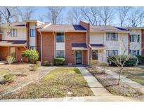 Brick front exterior of townhome with landscaping and walkway at 8465 Ramath Dr, Charlotte, NC 28211