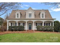 Two-story house with a front porch and landscaped yard at 14214 Sullivan Watch Dr, Huntersville, NC 28078