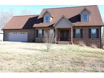 Brick house with brown roof, attached garage, and landscaping at 1592 Farmington Hills Dr, Conover, NC 28613