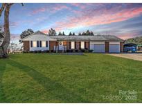 Charming brick home with a well-manicured lawn and an attached two-car garage at 3 Old Farm Rd, Salisbury, NC 28147