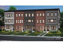 Modern townhome exterior showcasing brick and siding accents, landscaped lawns and black-framed windows at 309 Old Town Village Rd, Waxhaw, NC 28173