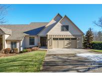 Craftsman style home with light beige siding, two-car garage, and landscaping at 3976 Stadler Ne Dr, Conover, NC 28613