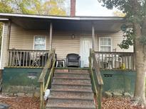Cozy house with a covered porch and steps leading to the entrance at 935 Brown St, Gastonia, NC 28052
