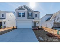 Charming two-story home with a two-car garage and well-maintained lawn at 1169 Red River Dr, Salisbury, NC 28144