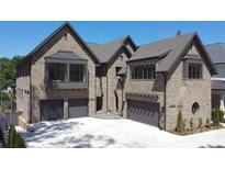 Beautiful brick home featuring a three-car garage and manicured landscaping at 1214 S Kings Dr # A, Charlotte, NC 28207
