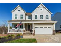 Charming two-story home with a welcoming front porch and an attached two-car garage at 14450 Maritime Dr, Lancaster, SC 29720
