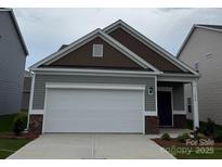 Charming home featuring a white garage door, brown accents, and neat landscaping at 1630 Troon Dr, Salisbury, NC 28144