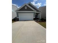 Charming single-Gathering home features a two-car garage, tidy landscaping, and a welcoming front porch at 1630 Troon Dr, Salisbury, NC 28144