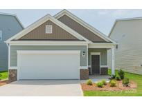 Charming single-story home with a two-car garage and beautifully landscaped front yard at 1630 Troon Dr, Salisbury, NC 28144