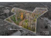 Aerial view of land bordered by an approximate lot line, surrounded by mature trees and nature at 2073 Mauney Rd, Bessemer City, NC 28016