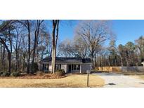 Newly built house with gray siding, black shutters, and a spacious yard at 2617 Mcarver St, Gastonia, NC 28052