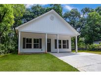 Charming single-story home featuring a covered porch and a well-manicured front yard at 408 N Boyd St, Gastonia, NC 28052